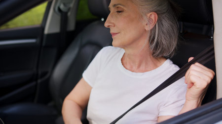 Successful Caucasian smiling elderly business woman mature female business woman auto driver car...