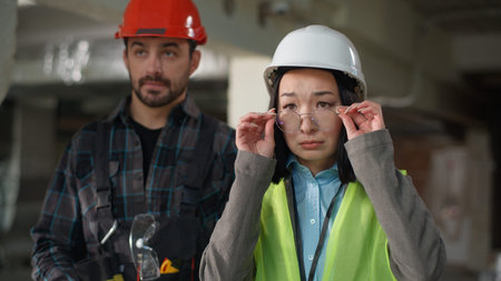 Multiethnic engineers disagreement reaction Japanese business woman inspector take off glasses...