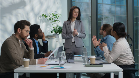 Multiethnic team businesswomen businessmen colleagues briefing talking discuss leader showing graph teamwork corporate office meeting work negotiation company coworkers employees business conferenceの写真素材