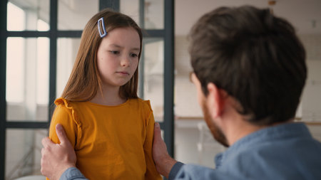 Caring Caucasian guy man parent touching offended frustrated little girl schoolgirl child quarrel dad male supporting frustrated daughter at home father comfort little kid family problem fatherhoodの写真素材