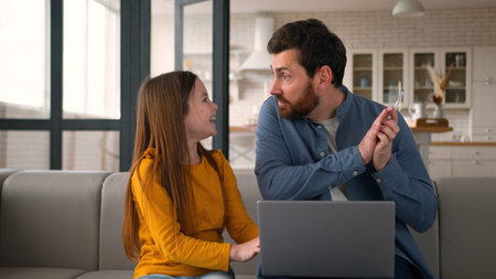Mischievous Caucasian little girl daughter kid interfering dad from remote freelance job angry...