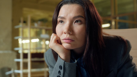 Asian woman architect business employer businesswoman working at office desk windmill electric power project thoughtful pensive Chinese Korean girl Japanese female planning thinking writing notes sadの写真素材