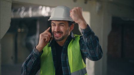 Frustrated Caucasian man arguing call angry builder speak mobile phone in construction architect...