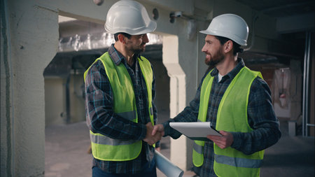 Glad Caucasian workers men guys holding draft papers mechanics working project architects plan build...