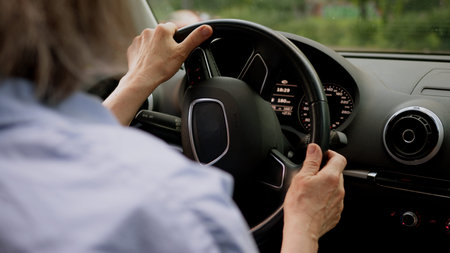 Back view Caucasian mature elderly business woman aged female businesswoman in glasses taxi driver...