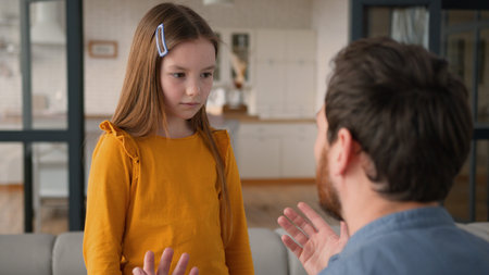 Stressed annoyed Caucasian dad male father man shout at upset daughter in fault kid at home conflict...