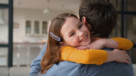 Smiling Caucasian family caring father male parent hugging embracing little girl kid happiness at home. Cheerful daughter child cuddling kiss cheek dad man love childcare tenderness custody parenthoodの写真素材