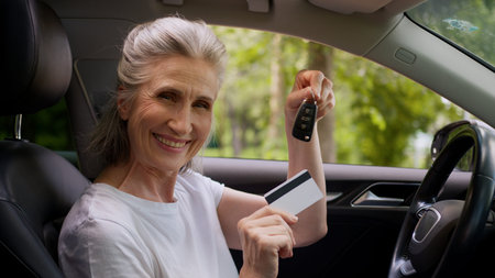 Happy joyful Caucasian smiling elderly senior woman female mature car automobile driver vehicle...