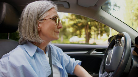 Satisfied relaxed Caucasian grandmother female elderly senior mature woman taxi driver auto car...