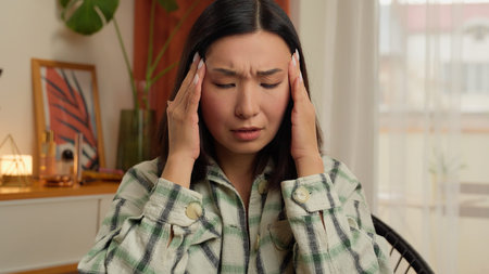 Asian Korean Chinese Japanese woman massage temples head headache suffer female health problem...