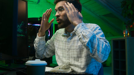 Worried Indian Arabian man guy streamer programmer hacker computer hope cross fingers loss failure...