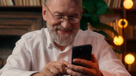 Confident successful old Caucasian man male mature takes off glasses looking at camera folded hands home office business businessman entrepreneur worker inside handsome elder employee portrait leaderの写真素材
