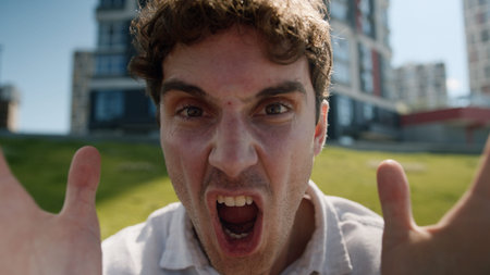 Close up angry Caucasian man male mad shouting at camera guy screaming stress city negative emotions...