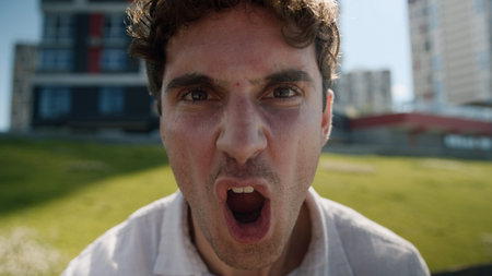 Close up angry Caucasian man male mad shouting at camera guy screaming stress city negative emotions...