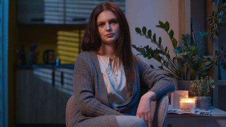 Sad woman portrait at home night evening upset disappointed pensive Caucasian worried frustrated girl looking at camera suffer loneliness problem health mental crisis depressed female displeased tiredの写真素材