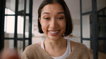 Webcam smartphone screen view happy Hispanic latino woman gadget addicted girl blogger female typing mobile phone touchscreen funny message laugh joyful smile touch cellphone display chatting at homeの写真素材