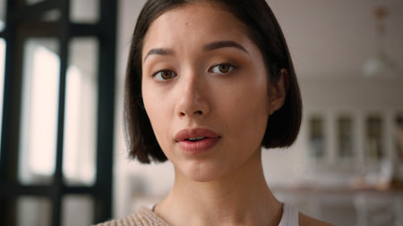 Close up female home portrait sad upset frustrated face emotions Caucasian Hispanic latino woman...