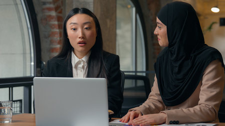 Two multiracial diversity business women co-workers employers multiethnic businesswomen girls Korean...