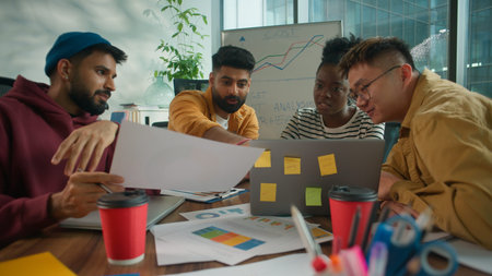 Focused concentrated informal casual startup business team considering paper document report...