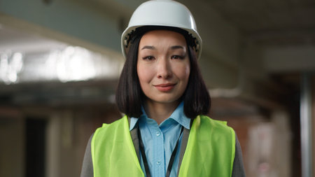 Portrait Asian Korean Chinese Japanese woman architect in hard hat female crossed hands builder...