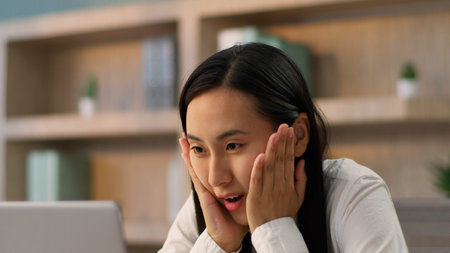 Close up surprised amazed Asian Japanese office worker manager business woman Chinese Korean female...