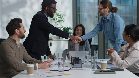 Multinational businessmen shaking hands handshake agreement success business deal offer financial team client partners businesswomen multiethnic women men negotiation cooperation office coworkers meetの写真素材