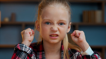 Portrait at home child kid girl little daughter in evening home looking at camera teen pupil feeling dissatisfied childhood problemの写真素材