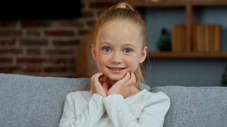 Portrait happy Caucasian cute girl kid daughter child smiling looking at camera carefree positive...