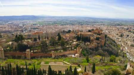 Aerial panoramic view of Alhambra fortress palace complex in Granada Spain with Sierra Nevada mountains historic Andalusian architecture UNESCO World Heritage site famous travel destination tourismの写真素材