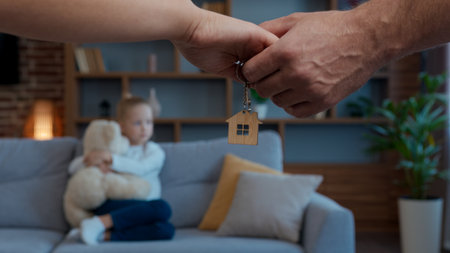 Caucasian family in own rental home male female hands holding bunch of keys daughter child kid girl with teddy bear tenant comfort renovation apartment insurance mortgage loan moving day accommodationの写真素材
