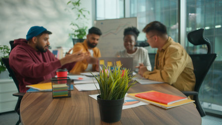 Happy diversity informal casual office business team colleagues working together Indian Asian Korean men support good idea of African woman with laptop four multiethnic people talking create projectの写真素材