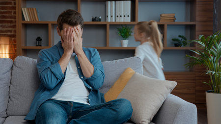 Stressed tired Caucasian father close face noisy daughter running family at home. Naughty girl active run playing dad feel stress headache with hyperactive kid child difficult parenting bad behaviorの写真素材