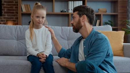 Caucasian family at home caring father support comforting sad daughter stressed upset child kid girl empathy supporting talking helping childcare problem parenting protection advice psychology helpの写真素材