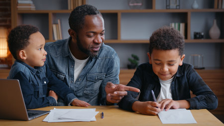 African American happy family father helping sons study education at home distant e-learning father with two boys kids children assistance with school homework teaching writing task with laptop talkの写真素材
