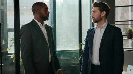 Diverse ethnic business men team businessmen talking formal communication in office male employers discussing project multiracial managers conversation Caucasian African American entrepreneurs meetingの写真素材