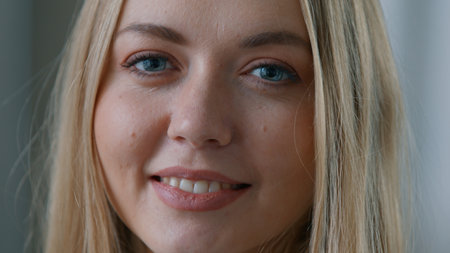 Close up portrait happy Caucasian woman smiling pretty face look smile looking at camera business worker in office businesswoman female girl headshot carefree healthy white teeth laughing indoorsの写真素材