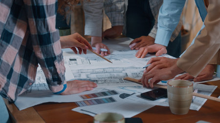 Creative casual informal business team group talking discuss building papers blueprint plan writing drawing communicate together five people diversity coworkers architects in office engineers talkの写真素材