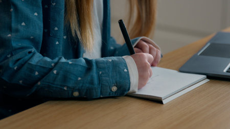 Close up cropped view Caucasian girl schoolgirl child kid daughter school pupil study writing notes...
