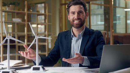 Confident Caucasian business green energy engineer presenting eco sources windmills at office male...