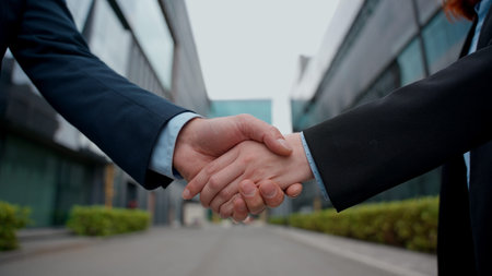Formal handshake businessman shaking hands businesswoman close up partnership business handshaking success shake arms together female male meeting agreement collaboration colleagues man woman in cityの写真素材