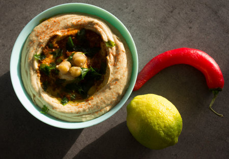 Plate of fresh homemade hummus with pita bread on the table. Authentic food of Middle East. Healthy...