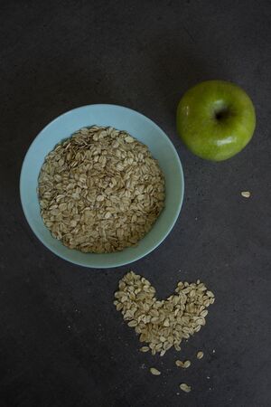 Healthy breakfast on a table. Bowl of oat meal and fresh fruits. Vegan food photo.の写真素材