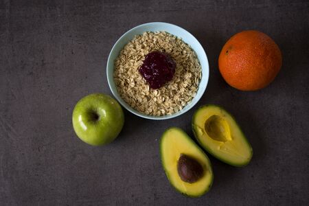 Healthy breakfast on a table. Bowl of oat meal and fresh fruits. Vegan food photo.の写真素材