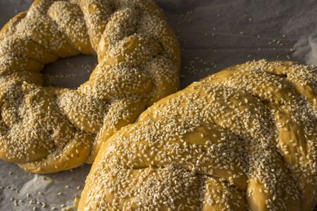 Challah bread on wooden table. Authentic food of Israel. Sabbath bread preparation.の写真素材