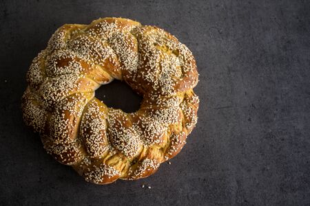 Challah bread on wooden table. Authentic food of Israel. Sabbath bread preparation.の写真素材