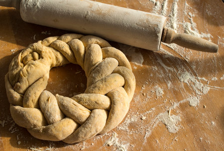 Challah bread on wooden table. Authentic food of Israel. Sabbath bread preparation.