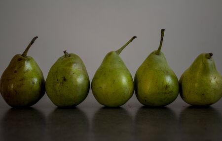 Green pears on dark grey background. Top view photo with copy space.の写真素材