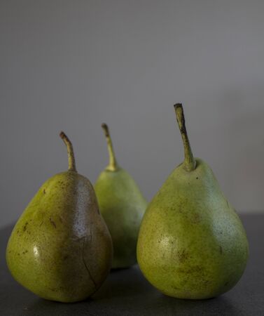 Green pears on dark grey background. Top view photo with copy space.の写真素材