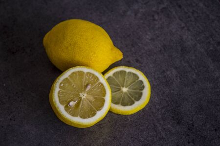 Fresh lemon on dark grey background. Copy space.の写真素材