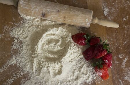 Making a cake. White flour and fresh strawberries on wooden table. Top view photo,の写真素材